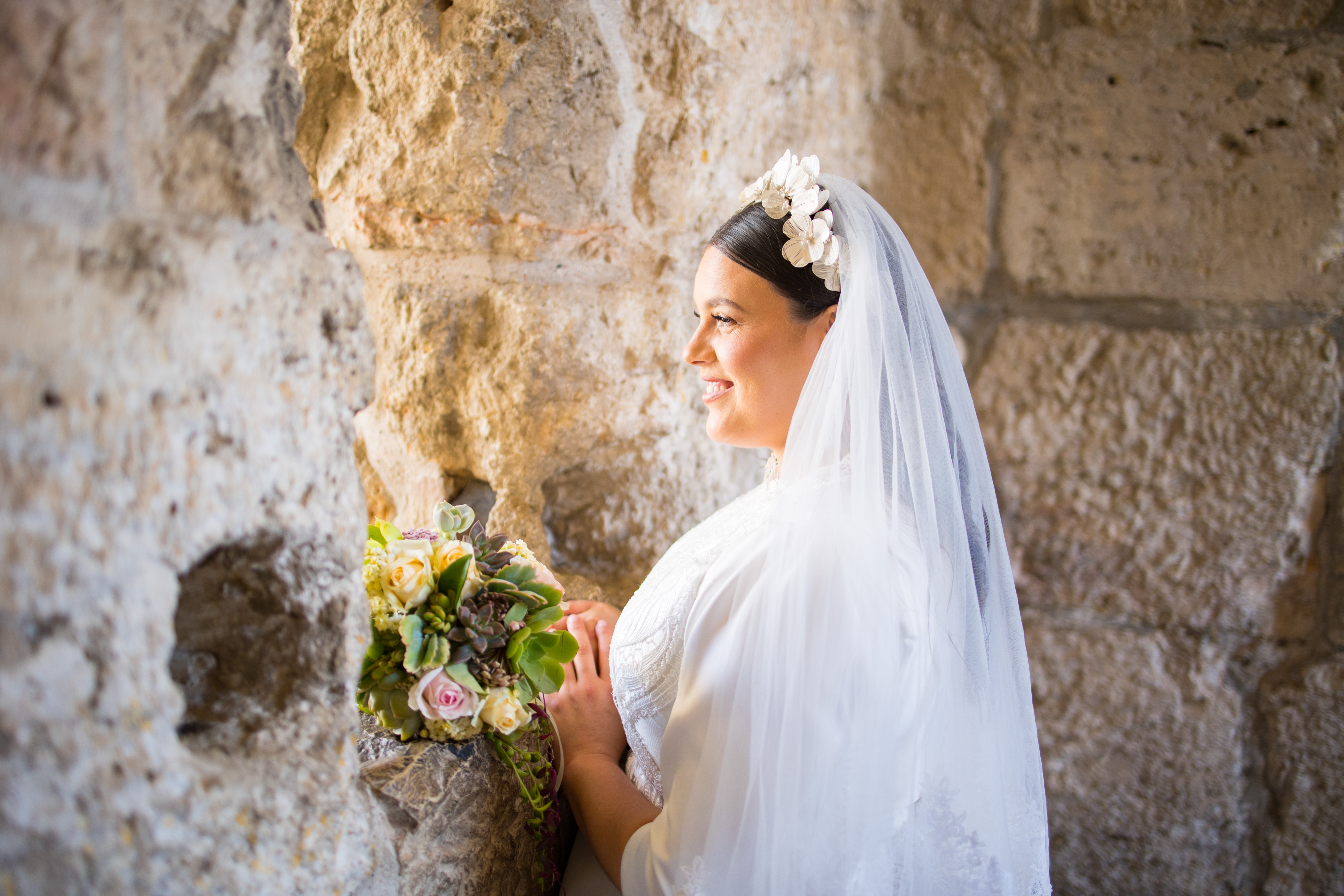 Bridal portrait beside a stone wall
