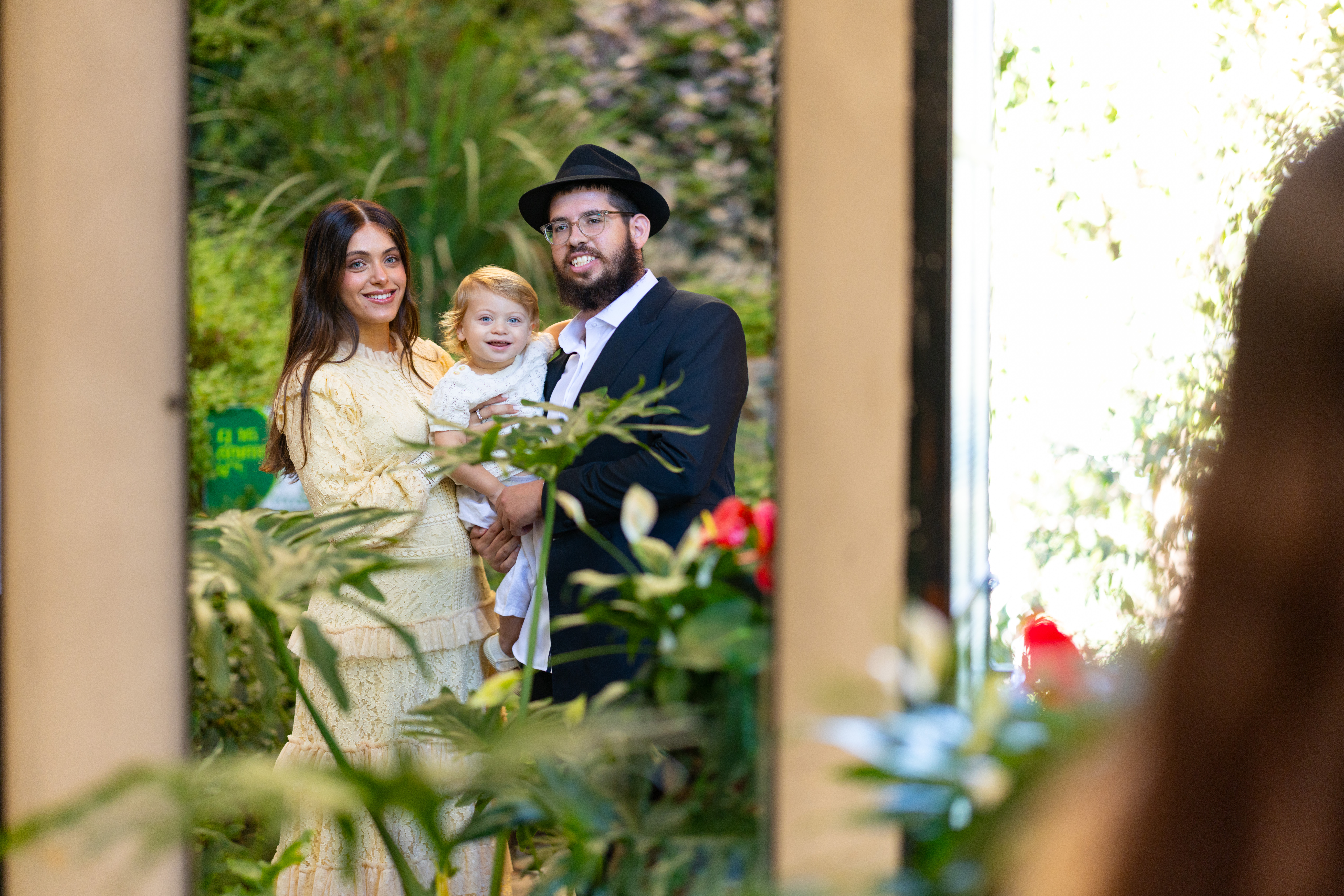 Parents with their child among flowers